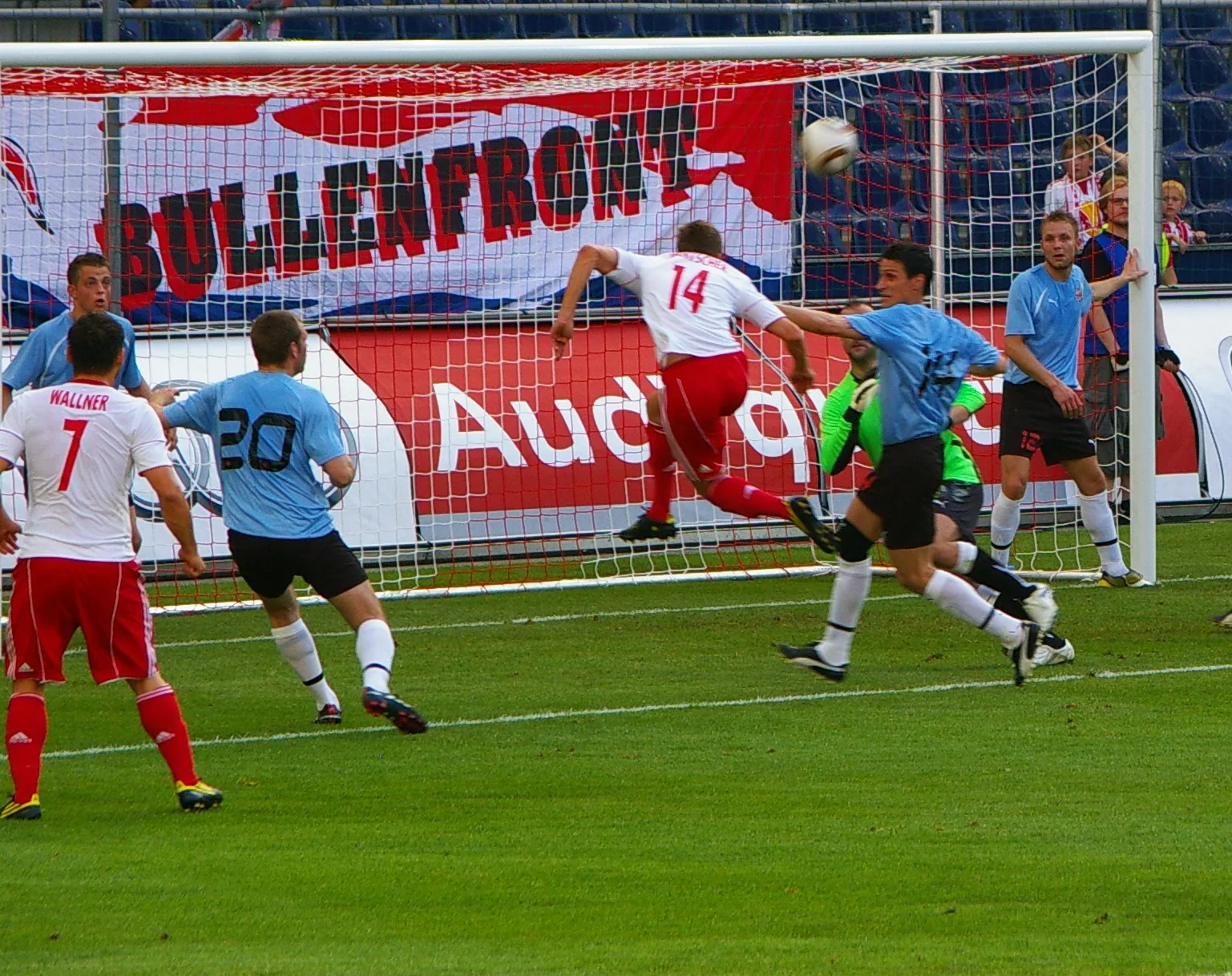 Players competing under floodlights during a European qualifying match