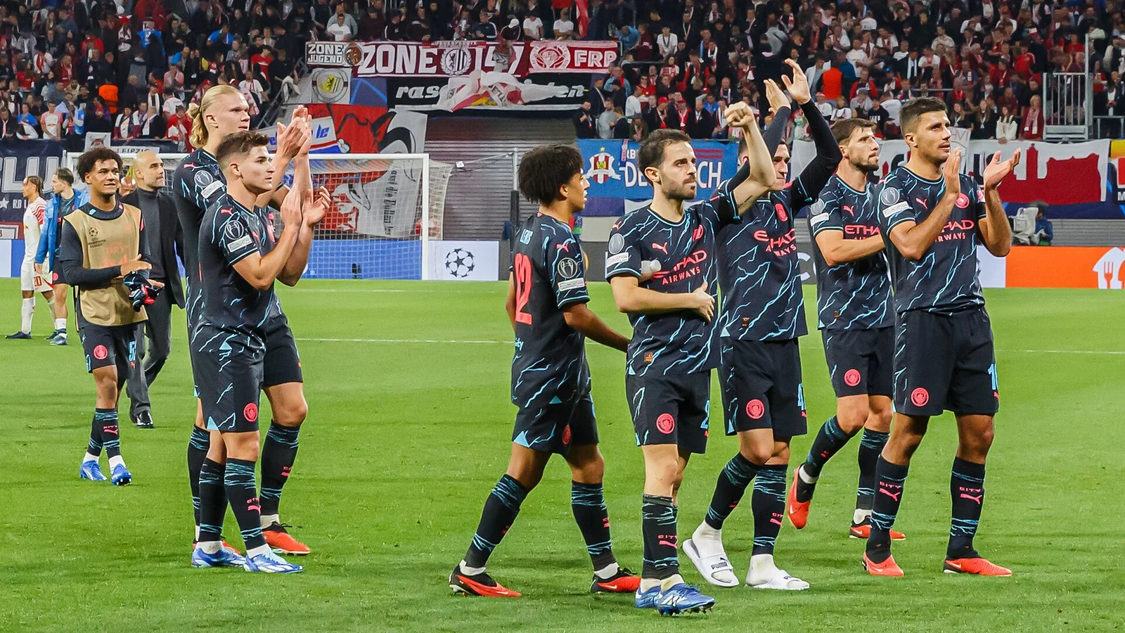 Manchester City players applauding supporters after a Champions League match in Leipzig in October 2023