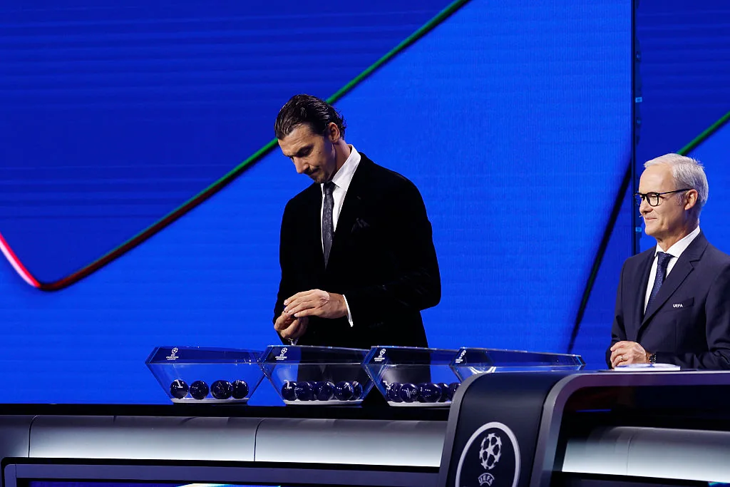 Zlatan Ibrahimovic selecting a ball beside Champions League draw bowls
