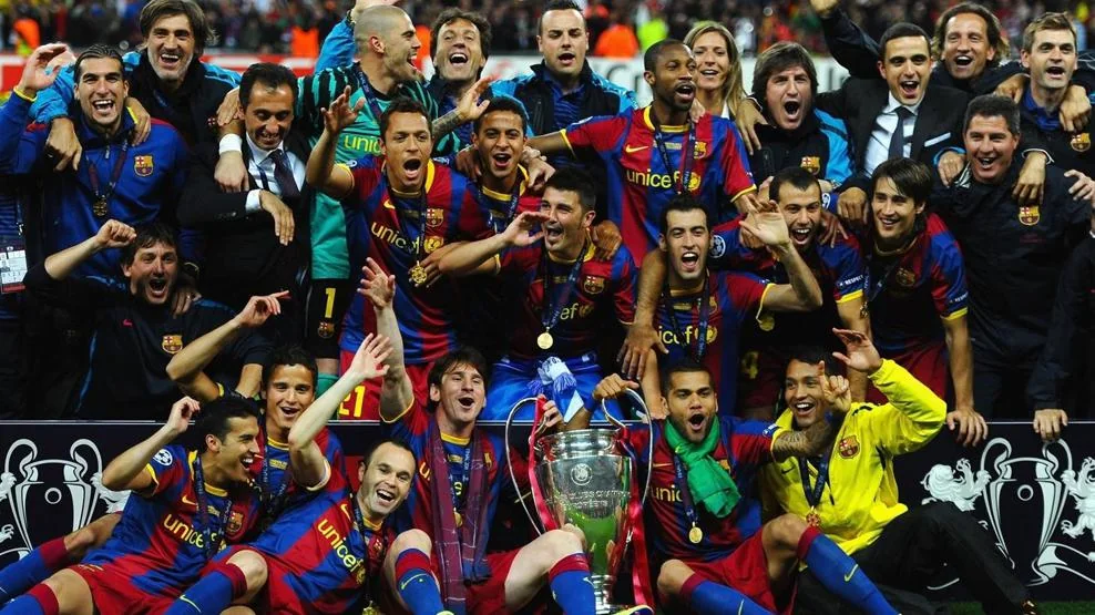 Barcelona players celebrating their 2011 Champions League win with the trophy at Wembley